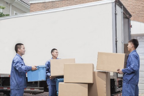 Workers loading moving equipment with ethical labour practices in mind